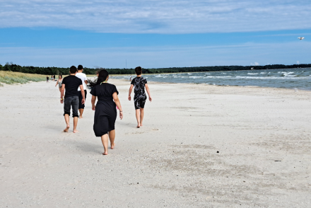 Lägerdeltagare och ledare på stranden.